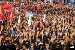 Supporters react as they listen to Turkey's President and ruling Justice and Development Party leader Recep Tayyip Erdogan during an election rally in Adiyaman, Turkey, June 1, 2018.