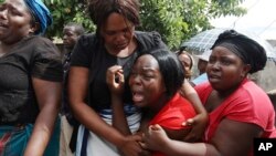 FILE: A family member of Kelvin Tinashe Choto reacts, during his funeral in Chitungwiza, about 30 kilometres south east of the capital, Harare, Zimbabwe, Saturday, Jan, 19, 2019.