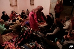 In this March 30, 2019 photo, Umm Yasser offers tea to during a women's only circle of tourists and Bedouin from the Hamada tribe, at her home in Wadi Sahw, Abu Zenima, in South Sinai, Egypt. (AP Photo/Nariman El-Mofty)