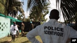Forensic scientists and doctors prepare for the exhumation of a mass grave site on the grounds of a mosque, in the Yopougon district of Abidjan, Ivory Coast, April 4, 2013.