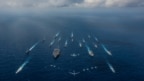 资料照：美国尼米兹级核动力航母“罗纳德·里根号”,日本海上自卫队“日向号”直升机驱逐舰,以及美日其他16艘战舰在菲律宾海进行演习。（2018年11月8日）