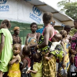Refugees, who fled the post-election instability in Ivory Coast, wait to be registered at a camp in Liberia