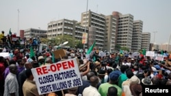 Anti-government protesters hold flags as they march in Abuja, Nigeria, Feb. 9, 2017.