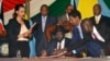 South Sudan President Salva Kiir, seated, signs a peace deal as Kenya’s President Uhuru Kenyatta, center-left, Ethiopia’s Prime Minister Hailemariam Desalegn, center-right, and Uganda’s President Yoweri Museveni, right, look on in Juba, South Sudan, Aug. 26, 2015.