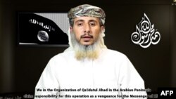 This image taken off a video posted online on January 14, 2015, by the media arm of Al-Qaeda in the Arabian Peninsula purportedly shows Nasser bin Ali al-Ansi claiming responsibility for the attack on the French magazine Charlie Hebdo.