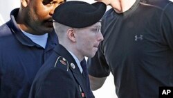 Army Pfc. Bradley Manning is escorted into a courthouse at Fort Meade, Maryland, June 4, 2013.