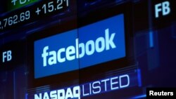 FILE - Monitors displays the Facebook, Inc. stock during morning trading at the NASDAQ Marketsite in New York, NY, U.S., June 4, 2012.