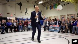 United States Sen. Cory Booker, D-N.J., center, addresses an audience during a 2020 presidential campaign stop in the gymnasium of a school, April 7, 2019, in Londonderry, N.H.