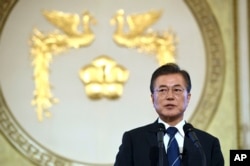 FILE - South Korean President Moon Jae-in speaks during a press conference marking his first 100 days in office at the presidential house in Seoul, Aug. 17, 2017. President Moon said Thursday he would consider sending a special envoy to North Korea for talks if