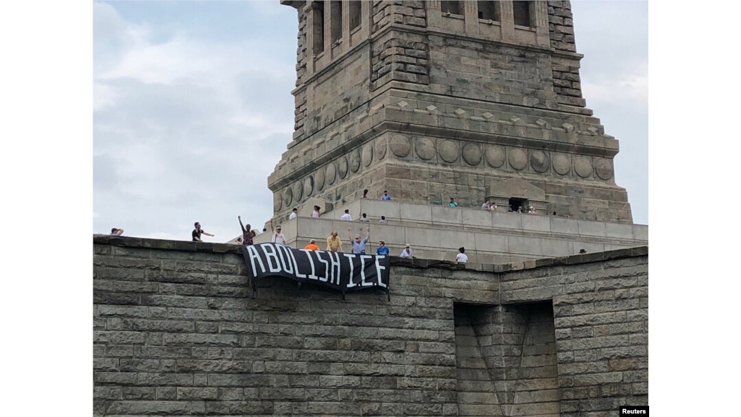 The group Rise and Resist stages a protest at the Statue of Liberty in New York, July 4, 2018, in this picture obtained from social media. (Rise and Resist/via Reuters)