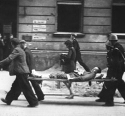 Members of the Polish Home Army carry a wounded comrade during the 1944 Warsaw Uprising against the German Nazis