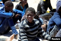 Migrants who'd attempted to flee to Europe wait in Libyan coast guard detention in the coastal city of Tripoli, Libya, May 16, 2016. The country's civil war has created openings for extremists, which Western governments hope to halt.