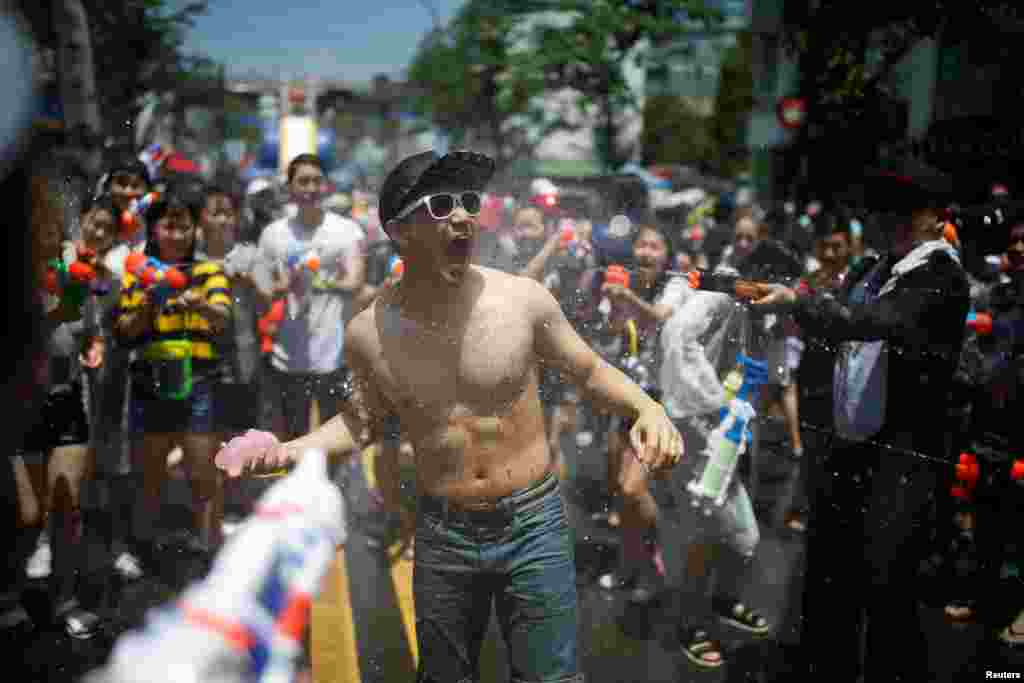 Participants play with water guns during the Sinchon Water Gun Festival in Seoul, South Korea.