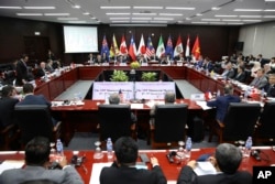 FILE - Trade ministers and delegates from the remaining members of the Trans Pacific Partnership (TPP) attend the TPP ministerial meeting on the sidelines of the Asia-Pacific Economic Cooperation (APEC) leaders summit, Nov. 9, 2017 in Danang, Vietnam.