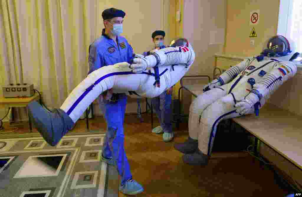 Employees prepare spacesuits at the Russian-leased Baikonur cosmodrome in Kazakhstan. Kazakhstan&#39;s cosmonaut Aydyn Aimbetov, Russian cosmonaut Sergei Volkov and Denmark&#39;s astronaut Andreas Mogensen from the European Space Agency, are scheduled to blast off to the International Space Station (ISS) on Sept. 2, 2015.