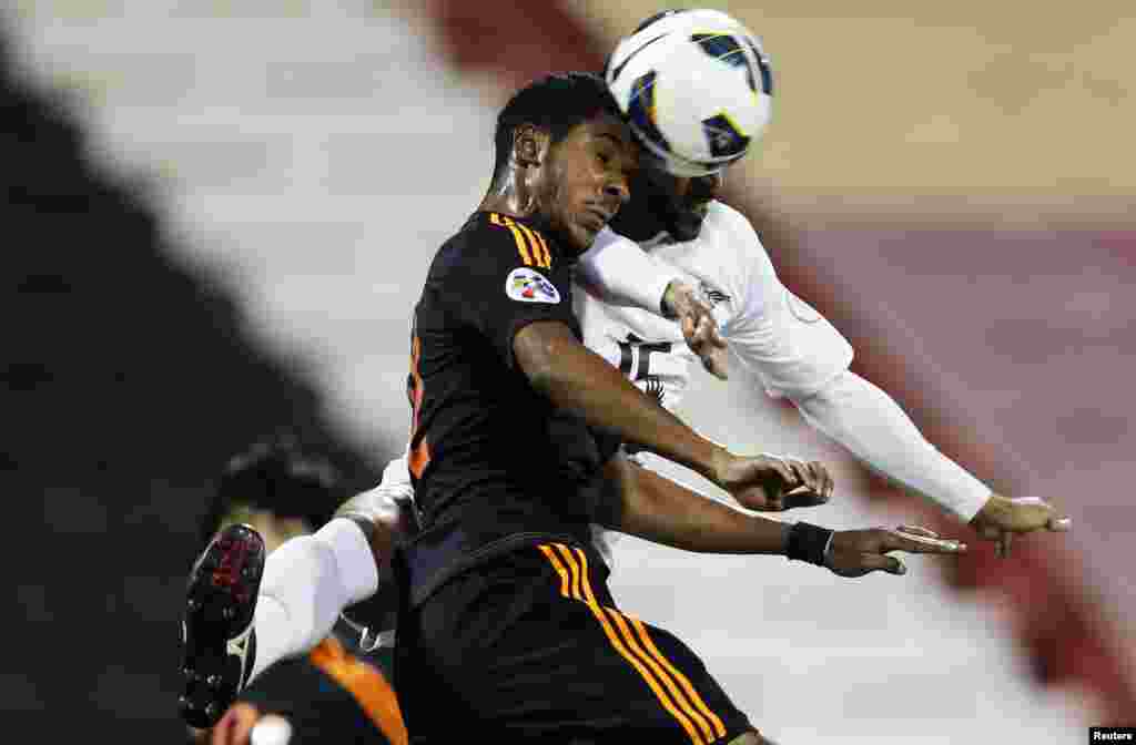 Majed Mohammed (R) of Qatar's El-Jaish fights for the ball with Nasser AlShamrani of Saudi Arabia's Al-Shabab during their AFC Champions League soccer match at the Al-Rayyan Stadium in Doha, Qatar.