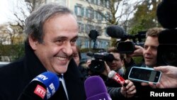 FILE - UEFA President Michel Platini smiles as he arrives for a hearing at the Court of Arbitration for Sport (CAS) in Lausanne, Switzerland, Dec. 8, 2015. 