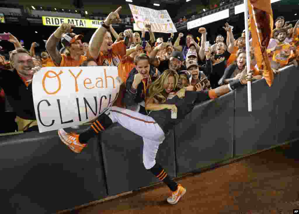 Baltimore Orioles center fielder Adam Jones celebrates with fans after a baseball game against the Toronto Blue Jays in Baltimore, Maryland, USA. Baltimore won 8-2 to clinch the American League East. 