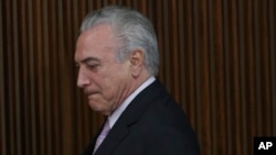 Brazil's President Michel Temer arrives to deliver a pension plan proposal to National Congress leaders at the Planalto Presidential Palace, in Brasilia, Dec. 5, 2016.
