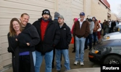 FILE - People wait in line to be among the first to legally buy recreational marijuana at the Botana Care store in Northglenn, Colorado, Jan. 1, 2014.