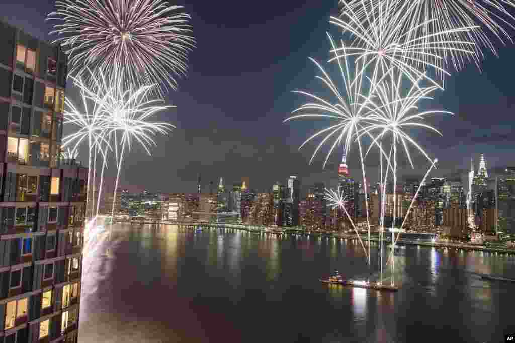 Pencakar langit New York City tampak di latar belakang saat atraksi kembang api di Hari Kemerdekaan di atas East River, 4 Juli 2017.