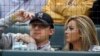 FILE - Cleveland Browns quarterback Johnny Manziel, left, sits with Colleen Crowley during a baseball game in Arlington, Texas, April 14, 2015.
