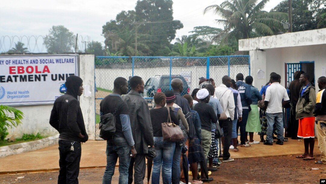 Liberian health workers queue to enter one of the largest Ebola treatment units at the Island Clinic Monrovia, Liberia. Oct. 13, 2014.