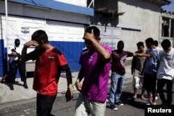 Suspected members of the 18th Street gang are presented to the media after they were arrested in a raid in San Salvador, El Salvador, Aug. 19, 2015.