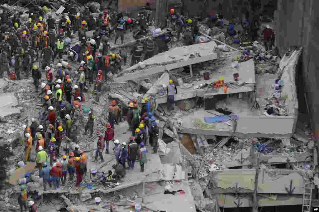 Rescue workers search for people trapped inside a collapsed building in the Del Valle area of Mexico City, Sept. 20, 2017.