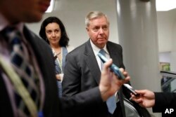 FILE -Sen. Lindsey Graham, R-S.C. is followed by reporters on Capitol Hill in Washington, May 23, 2017.