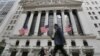 FILE - People walk by the New York Stock Exchange, June 24, 2016.