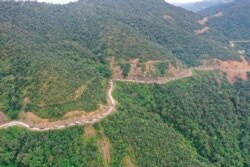 In this Oct. 14, 2021, aerial photo released by the Chin Human Rights Organization, a military convoy approaches Thantlang in Chin State in northwest Myanmar.