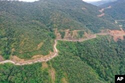 FILE - In this Oct. 14, 2021, aerial photo released by the Chin Human Rights Organization, a military convoy approaches Thantlang in Chin State in northwest Myanmar.