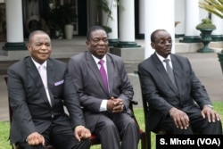 President Emmerson Mnangagwa (center) flanked by his just sworn in vice presidents at the State House, Harare, Zimbabwe, Dec. 28, 2017.