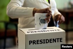 A voter casts his ballot during the presidential election at a polling station in San Jose, Costa Rica, Feb. 4, 2018.