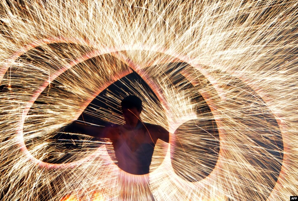 A fire artist performs during the Minsk International Fire Fest in Ratomka, near Minsk, Belarus, Aug.19, 2016.