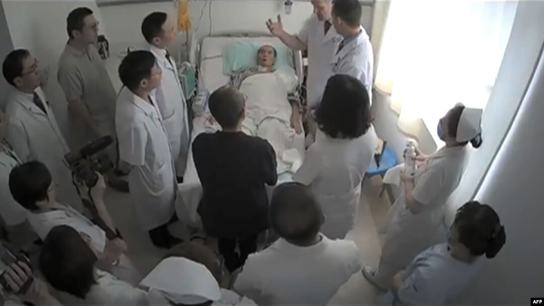 This undated video grab obtained on July 11, 2017, shows Chinese Nobel Laureate Liu Xiaobo (C) surrounded by doctors and his wife Liu Xia at an undisclosed location.