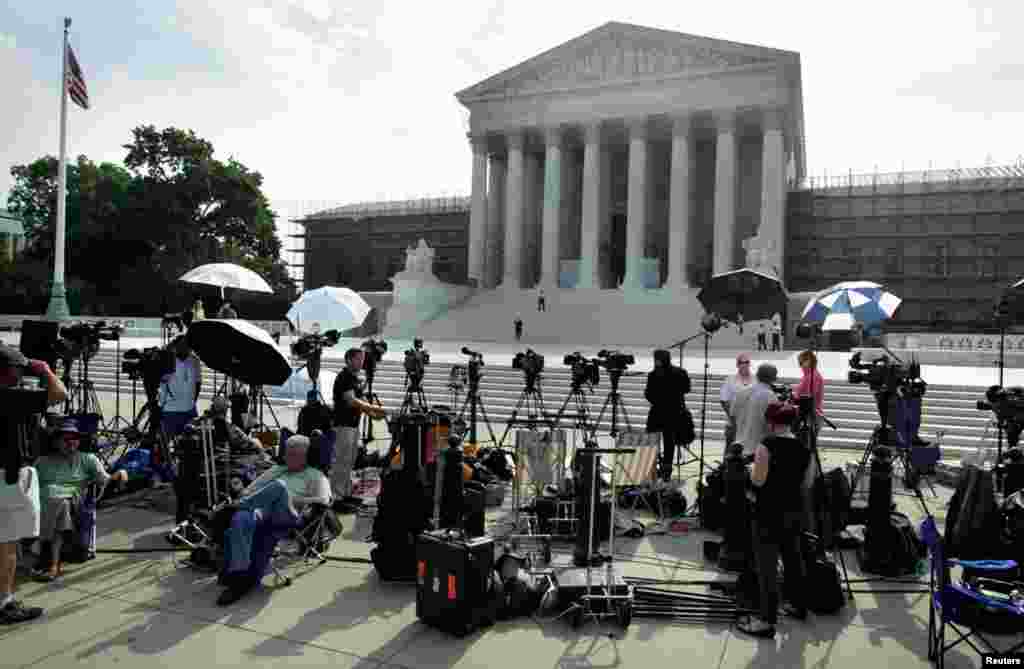 Members of the media gather for a stakeout in front of U.S. Supreme Court in Washington.