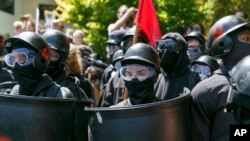 Counter-protesters prepare to clash with Patriot Prayer protesters during a rally in Portland, Ore., Saturday, Aug. 4, 2018.