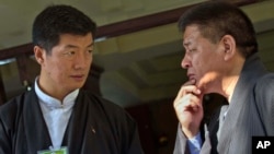 FILE - Prime Minister of the exile Tibetan government, Lobsang Sangay, left, talks to Speaker of the exile Tibetan parliament, Penpa Tsering, in Dharmsala, India.