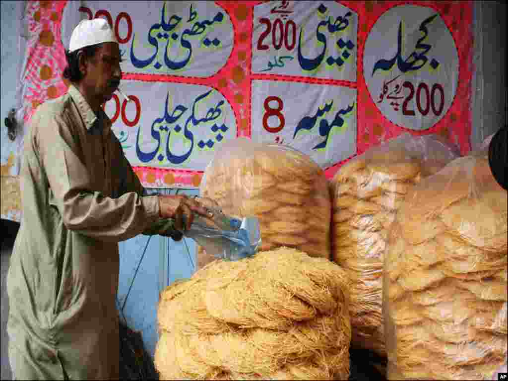 A baker preparing Pheni at his bakery as they are in high demand during Ramadan. 