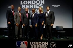 Tim Slavin of the Major League Baseball Players Association, left with John Henry owner of the Boston Red Sox, Robert D Manfred Commissioner of the MLB, Sadiq Khan the Mayor of London, Jennifer Steinbrenner Swindal and Hal Steinbrenner left with joint owners of the New York Yankees, pose following press conference in London, May 8, 2018, to announce a two game series to be played in London.