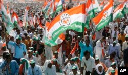 FILE - Supporters of India's main opposition Congress party attend a public meeting at Adalaj in Gandhinagar, India, March 12, 2019.