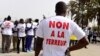 FILE - People wearing T-shirt reading "no to terror" demonstrate in Dakar, April 22, 2016. On Friday, a court in Dakar sentenced more than a dozen suspected militants to prison.