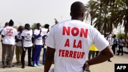 FILE - People wearing T-shirt reading "no to terror" demonstrate in Dakar, April 22, 2016. On Friday, a court in Dakar sentenced more than a dozen suspected militants to prison.