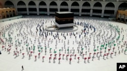 Hundreds of Muslim pilgrims circle the Kaaba as they keep social distance to protect themselves against the coronavirus ahead of the Hajj pilgrimage in the Muslim holy city of Mecca, Saudi Arabia, July 29, 2020. (AP Photo)