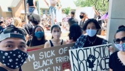 Archawee Dhamavasi (right), a 43-year-old Thai-American mother goes to a Black Lives Matter protest with her daugther, Natasha Dhamvasi (second from left), in Downers Grove village, Illinois on June 7, 2020