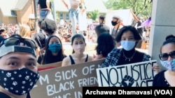 Archawee Dhamavasi (right), a 43-year-old Thai-American mother goes to a Black Lives Matter protest with her daugther, Natasha Dhamvasi (second from left), in Downers Grove village, Illinois on June 7, 2020