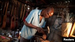 Guitar luthier Misoko Nzalayala Jean-Luther, alias Socklo, 61, works at his workshop in Kinshasa, Democratic Republic of Congo, Oct.18, 2021.