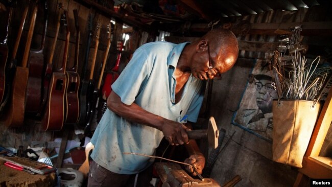 Guitar luthier Misoko Nzalayala Jean-Luther, alias Socklo, 61, works at his workshop in Kinshasa, Democratic Republic of Congo, Oct.18, 2021.